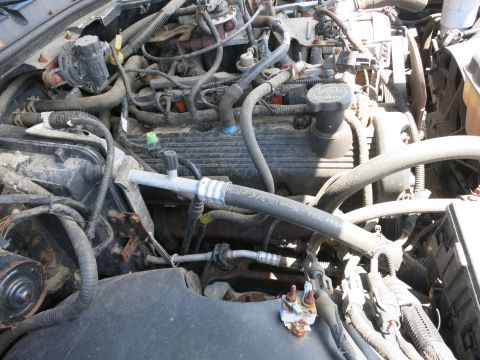 1991 Ford LTD Crown Victoria - Close-up view of a vehicle's engine bay, showing various mechanical parts and hoses.