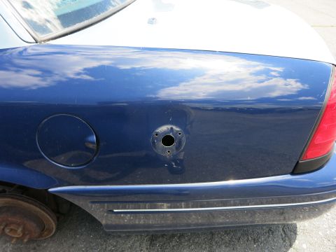 1991 Ford LTD Crown Victoria - Rear quarter panel detail of a 1991 Ford Crown Victoria LTD, showing the fuel door and a hole for an antenna mount.