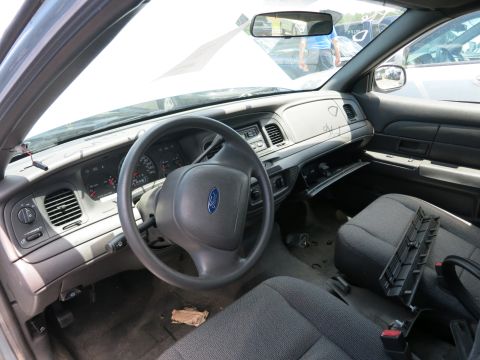 1991 Ford LTD Crown Victoria - The interior of a Ford Crown Victoria shows wear and tear, with the glove compartment left open.