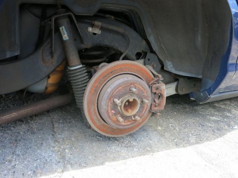 1991 Ford LTD Crown Victoria - Close-up of a vehicle's rear brake assembly and suspension components.