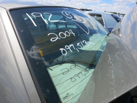 1991 Ford LTD Crown Victoria - White markings on the rear window of a car indicate a 2004 date and mileage.