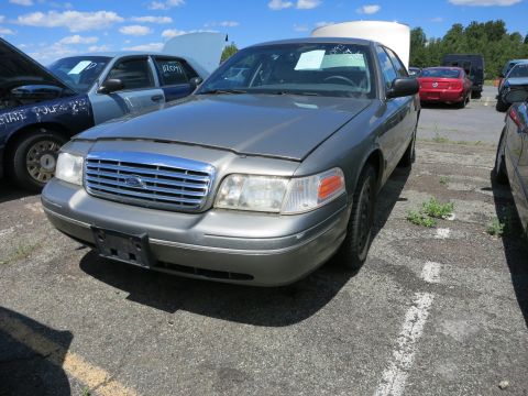 1991 Ford LTD Crown Victoria - A gray Ford Crown Victoria is parked in an outdoor lot with other vehicles visible.