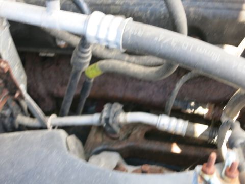 1991 Ford LTD Crown Victoria - Engine bay components, including hoses and metal parts, are visible in this close-up shot.