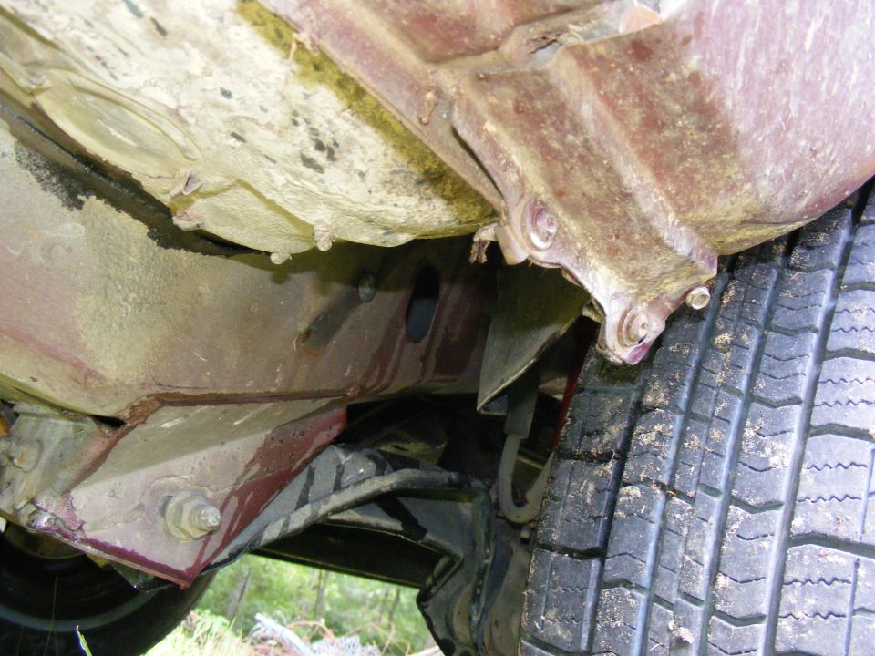 Undercarriage of a 1978 Ford Bronco showing frame and tire