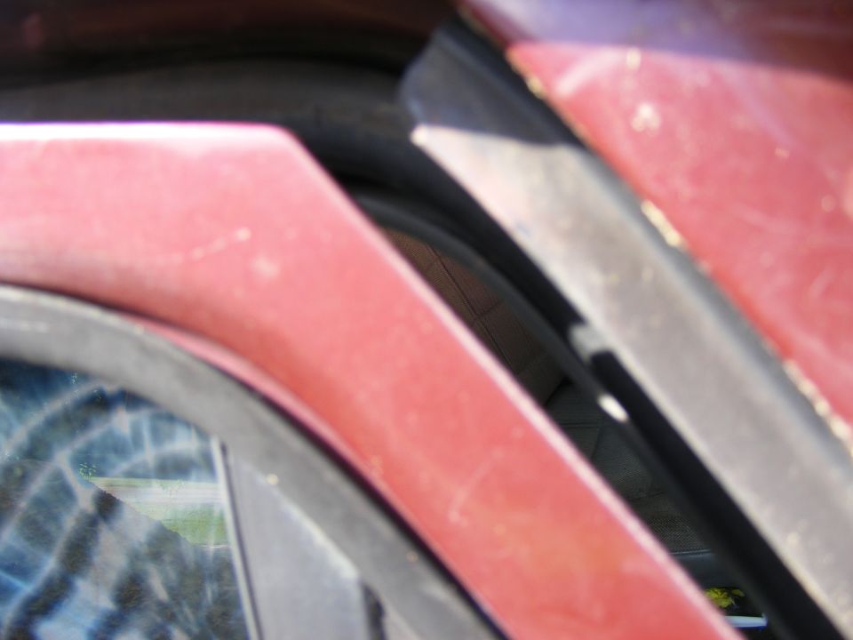 Red vehicle door frame and tire detail