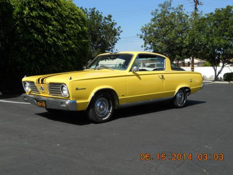 1966 Plymouth Barracuda - A yellow 1966 Plymouth Barracuda is parked outside on a sunny day.