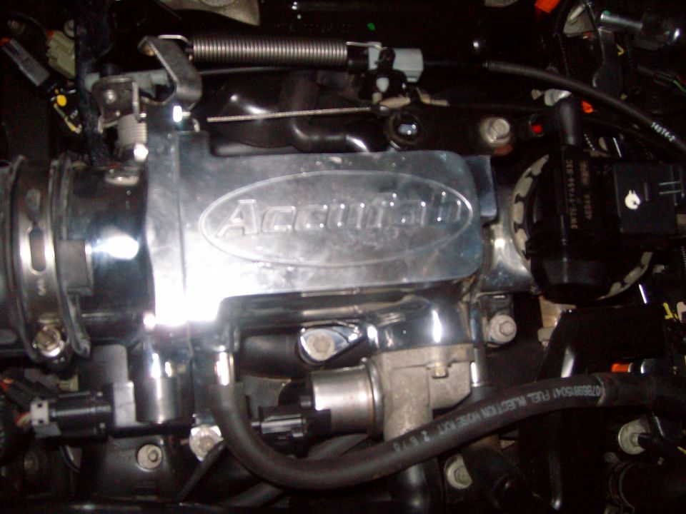 Chrome Accufab throttle body with black hoses and wiring