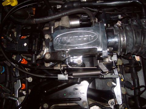 2004 Ford Crown Victoria - Close-up of a chrome Accufab throttle body installed in an engine bay, showing various hoses and wiring.