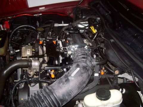2004 Ford Crown Victoria - Close-up view of the engine compartment, showing various mechanical parts and wiring.