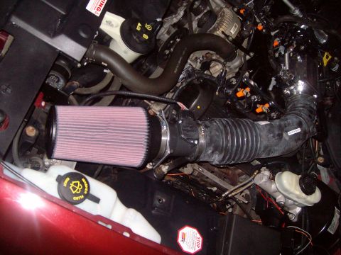 2004 Ford Crown Victoria - Close-up view of a vehicle's engine bay, highlighting an aftermarket air intake system.