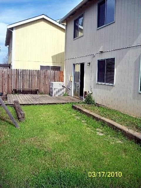 1989 Ford Bronco - A backyard scene shows a wooden deck and lawn between two houses, with a date stamp of 03/17/2010.