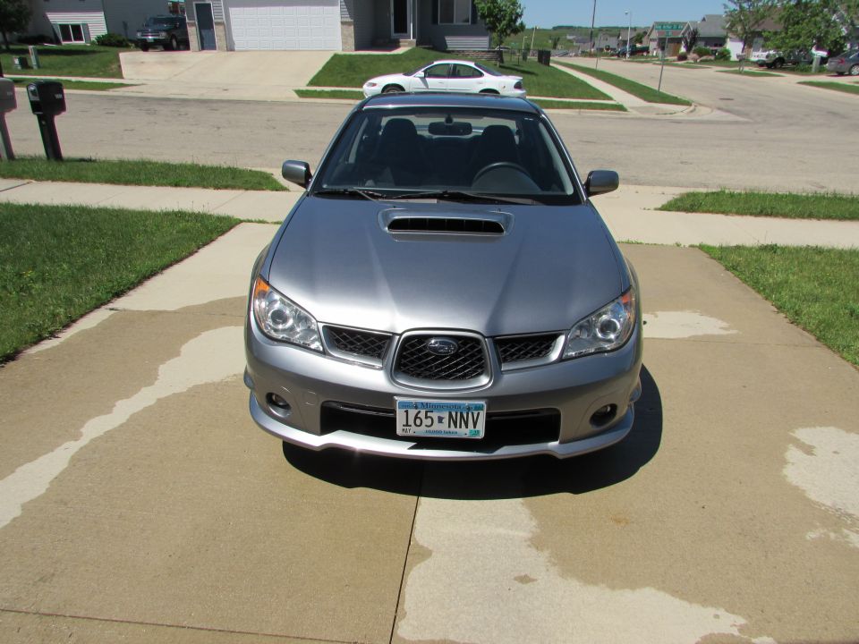 Front view of a silver 2007 Subaru Impreza WRX with a hood scoop and license plate 165-NNV
