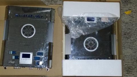 2007 Subaru Impreza - Two car audio amplifiers are shown, one is unboxed and the other is still in its packaging.