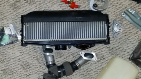 2007 Subaru Impreza - Intercooler and associated intake piping are laid out on a carpeted surface, with a Supermotors.net logo visible at the bottom right.