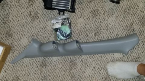 2007 Subaru Impreza - Aftermarket A-pillar gauge pod and intercooler parts laid out on a carpeted floor.