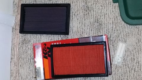 2007 Subaru Impreza - K&N air filters shown on a carpeted surface, with one filter in its original packaging.