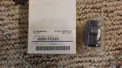 2007 Subaru Impreza - A box labeled Subaru genuine parts sits next to a water spray nozzle, likely for a vehicle's intercooler system.