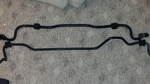 2007 Subaru Impreza - Two sway bars, likely for a vehicle's suspension system, are laid out on a carpeted floor.