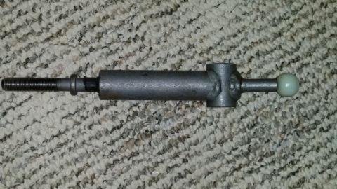 2007 Subaru Impreza - A close-up view of a metal automotive part, possibly a gear shift linkage, is shown against a textured background.