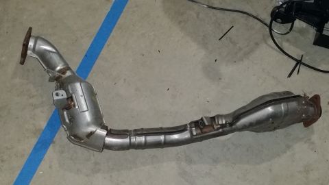 2007 Subaru Impreza - This is a vehicle exhaust component, likely a catalytic converter and pipe assembly, shown on a floor.