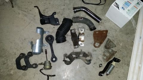 2007 Subaru Impreza - Collection of various automotive parts laid out on a concrete surface.