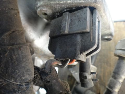 1993 Ford Taurus - Detail of a vehicle's electrical system, showing a connector and wiring.