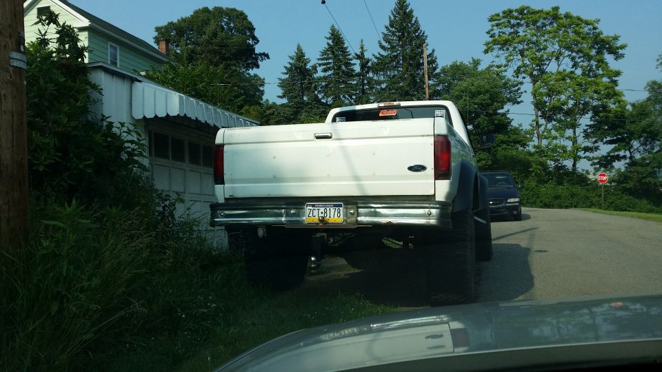 1995 Ford F-350 pickup truck parked next to a house, rear view