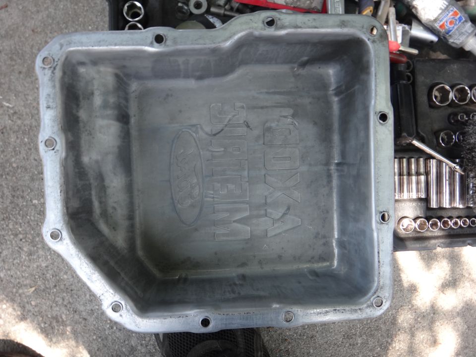 Aluminum oil pan with embossed Ford logo and text