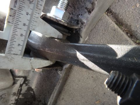 1993 Ford Taurus - Measuring automotive part thickness with a caliper. Scale shows approximately 25mm.