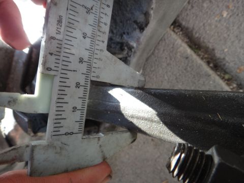 1993 Ford Taurus - A caliper is used to measure the dimensions of a vehicle component.