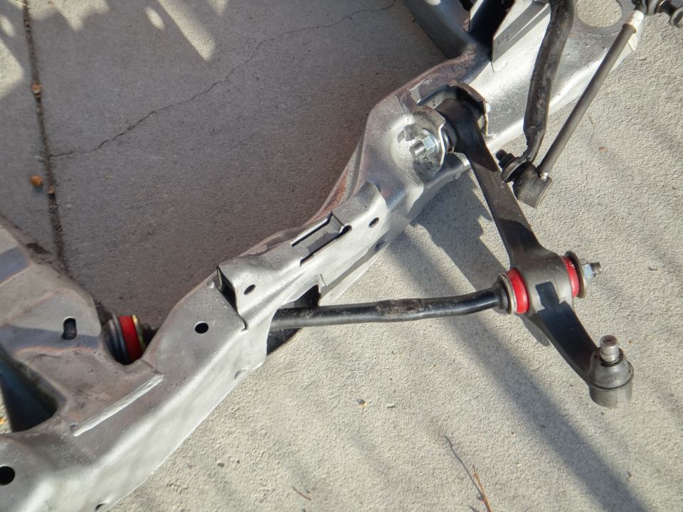 Car subframe assembly with red polyurethane bushings, sway bar, and control arm