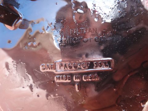 1993 Ford Taurus - This is a close-up of a part with text stamped on it, indicating it's a FILTRAN MicroFel SAE PA66+CF 33% made in the USA.