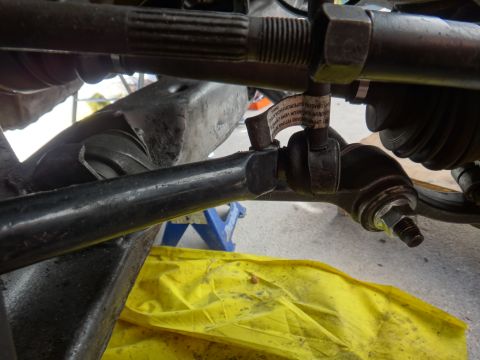 1993 Ford Taurus - Close-up view of a vehicle's steering linkage system, with a yellow cloth visible below.