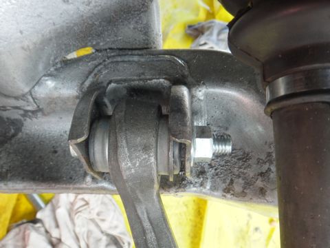 1993 Ford Taurus - A detailed view of a vehicle's suspension system, focusing on a bolted connection.