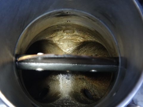 1993 Ford Taurus - Close-up view of the inside of a vehicle's throttle body, showing buildup and wear.