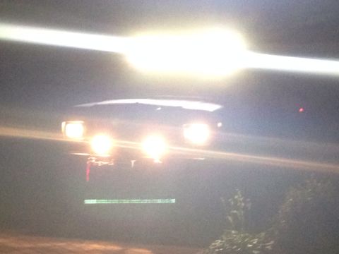 1979 Ford Bronco - Front view of a 1979 Ford Bronco at night, its headlights are on.