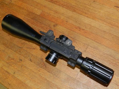 1996 Ford Bronco - A detailed view of a rifle scope, adjustable turrets and a large objective lens.