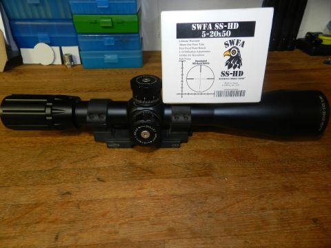 1996 Ford Bronco - A SWFA SS-HD 5-20x50 rifle scope is shown with its original packaging on a wooden surface.