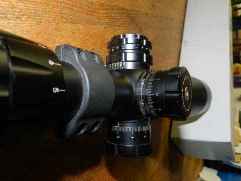 1996 Ford Bronco - This is a close-up view of a rifle scope, showing its various adjustment turrets and markings.
