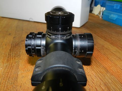 1996 Ford Bronco - A close-up view of a rifle scope's turrets and adjustment markings.
