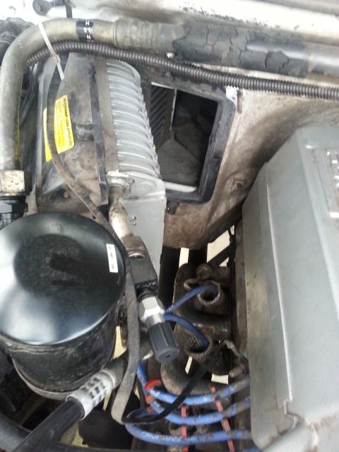 1992 Ford Bronco - Close-up view of the evaporator box and surrounding engine components within a vehicle.
