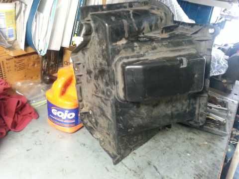 1992 Ford Bronco - Automotive HVAC evaporator housing shown with cleaning supplies and shop rags.