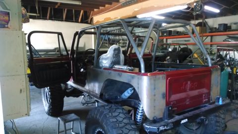 1985 Jeep CJ7 - This 1985 Jeep CJ7 is undergoing modifications in a garage setting.