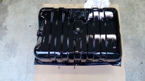 1983 Ford Bronco - A freshly painted black fuel tank is shown, ready for installation.