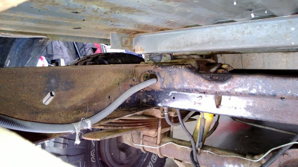 Undercarriage of a 1983 Ford Bronco showing frame and suspension components