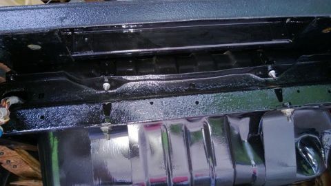 1983 Ford Bronco - The undercarriage of a vehicle, a freshly painted frame and fuel tank assembly.