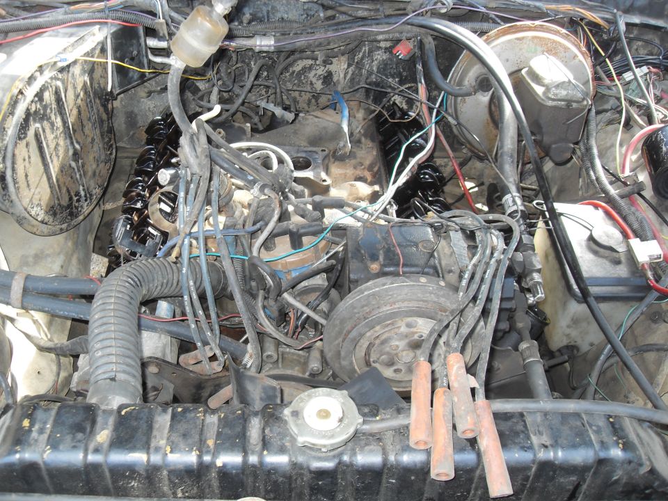 Engine bay with V8 engine, radiator, and wiring visible