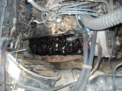 1979 Ford Bronco - The engine bay shows internal components with the valve cover removed, revealing the rocker arms and lubrication.