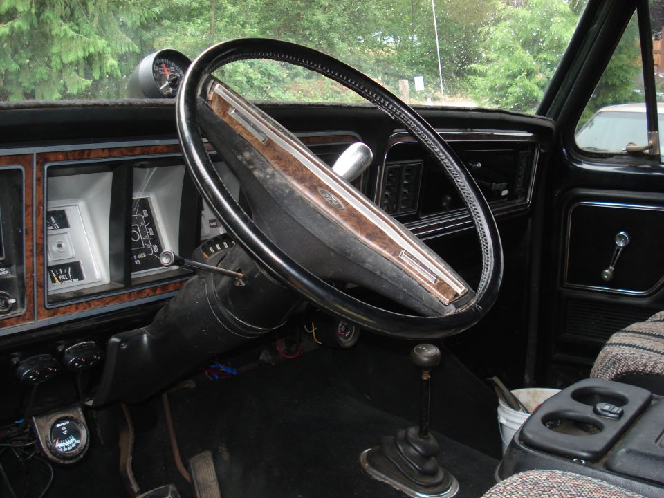 1979 Ford Bronco interior showing dashboard, steering wheel, and floor shifter