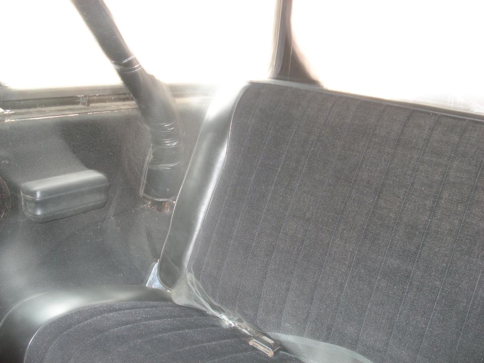 Vehicle interior showing a seat and roll bar